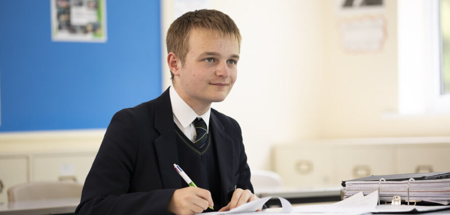 Boy studying in classroom